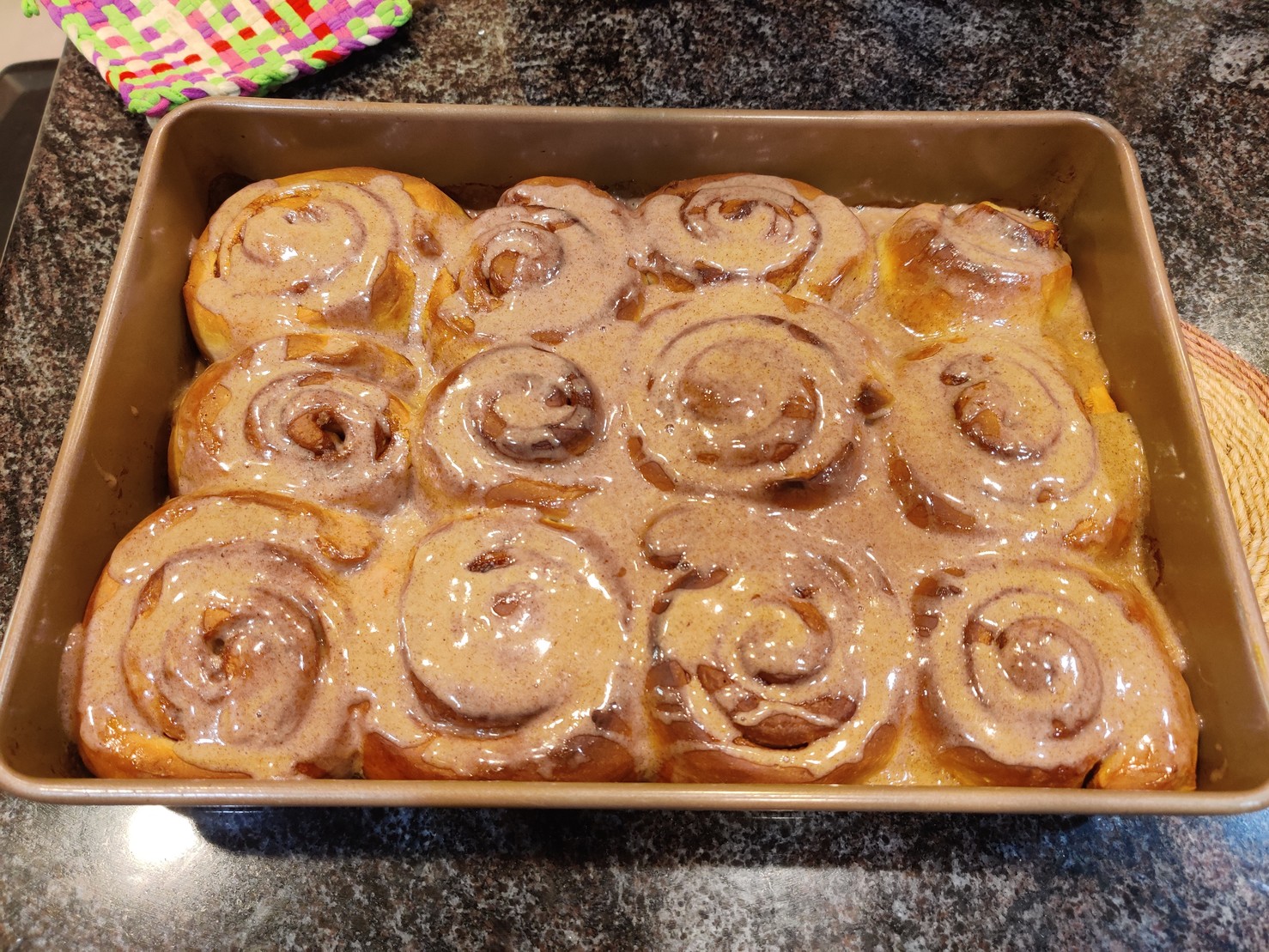 12 cinnamon rolls with frosting on them