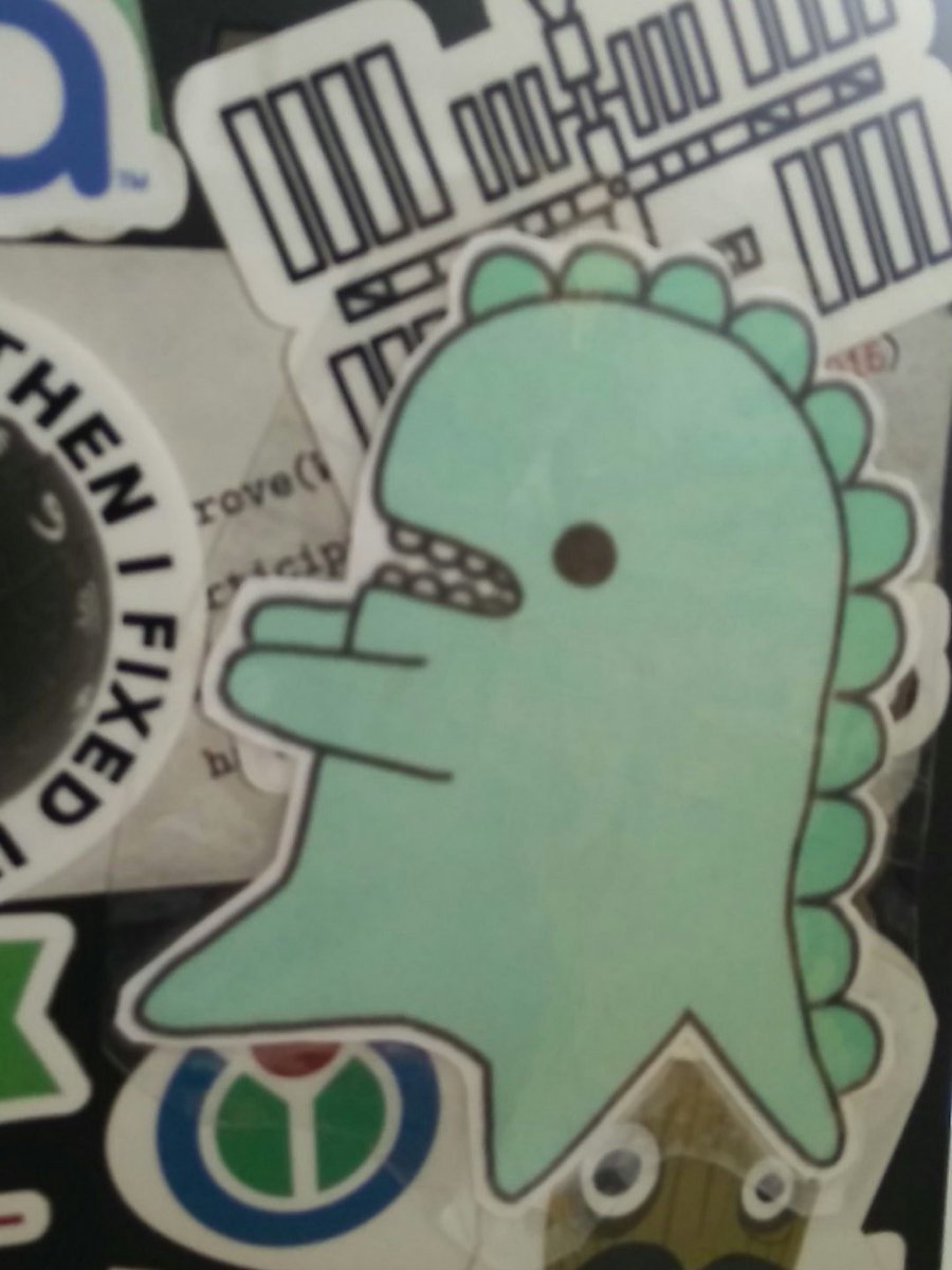 A laptop with a cute dinosaur sticker on it