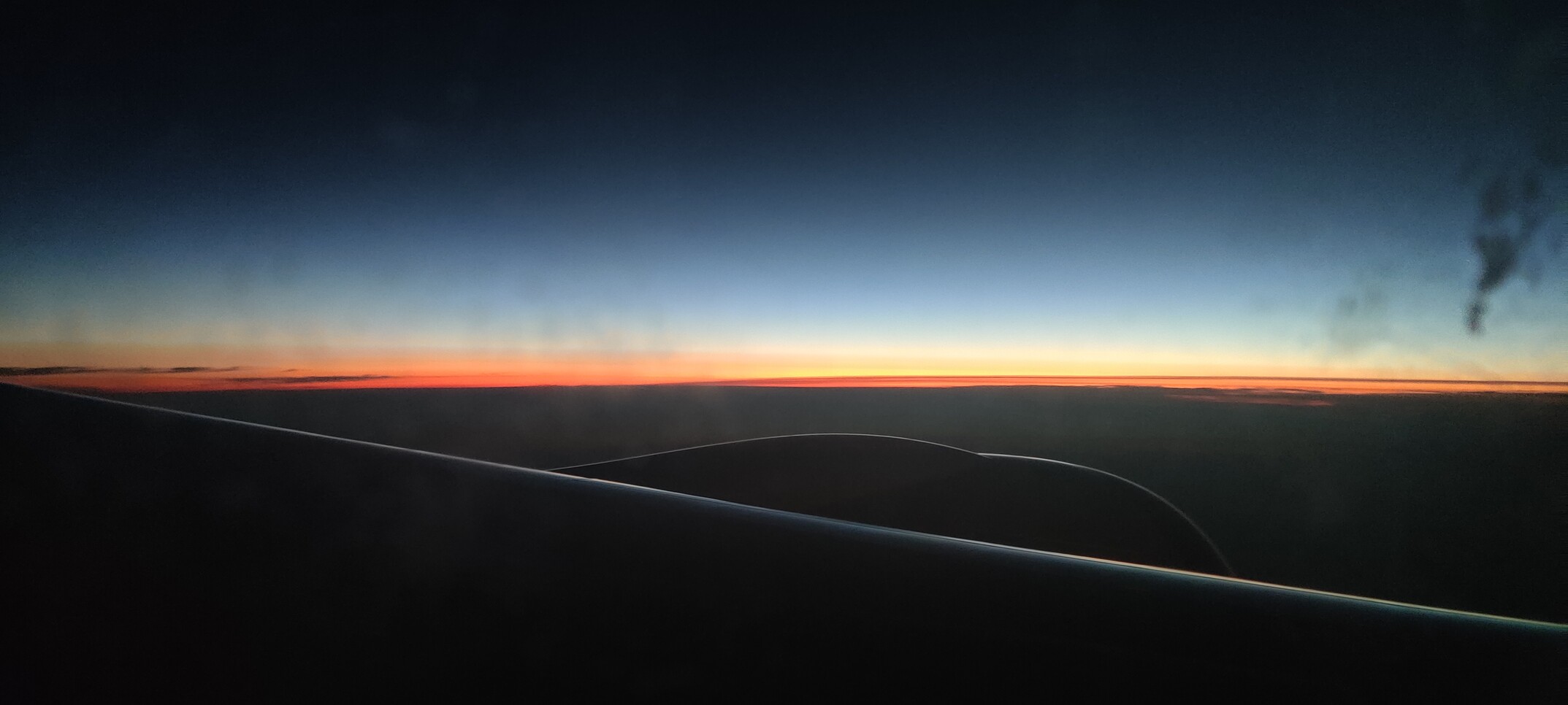 Pretty orange glow at the horizon, taken from a plane somewhere over Iowa.