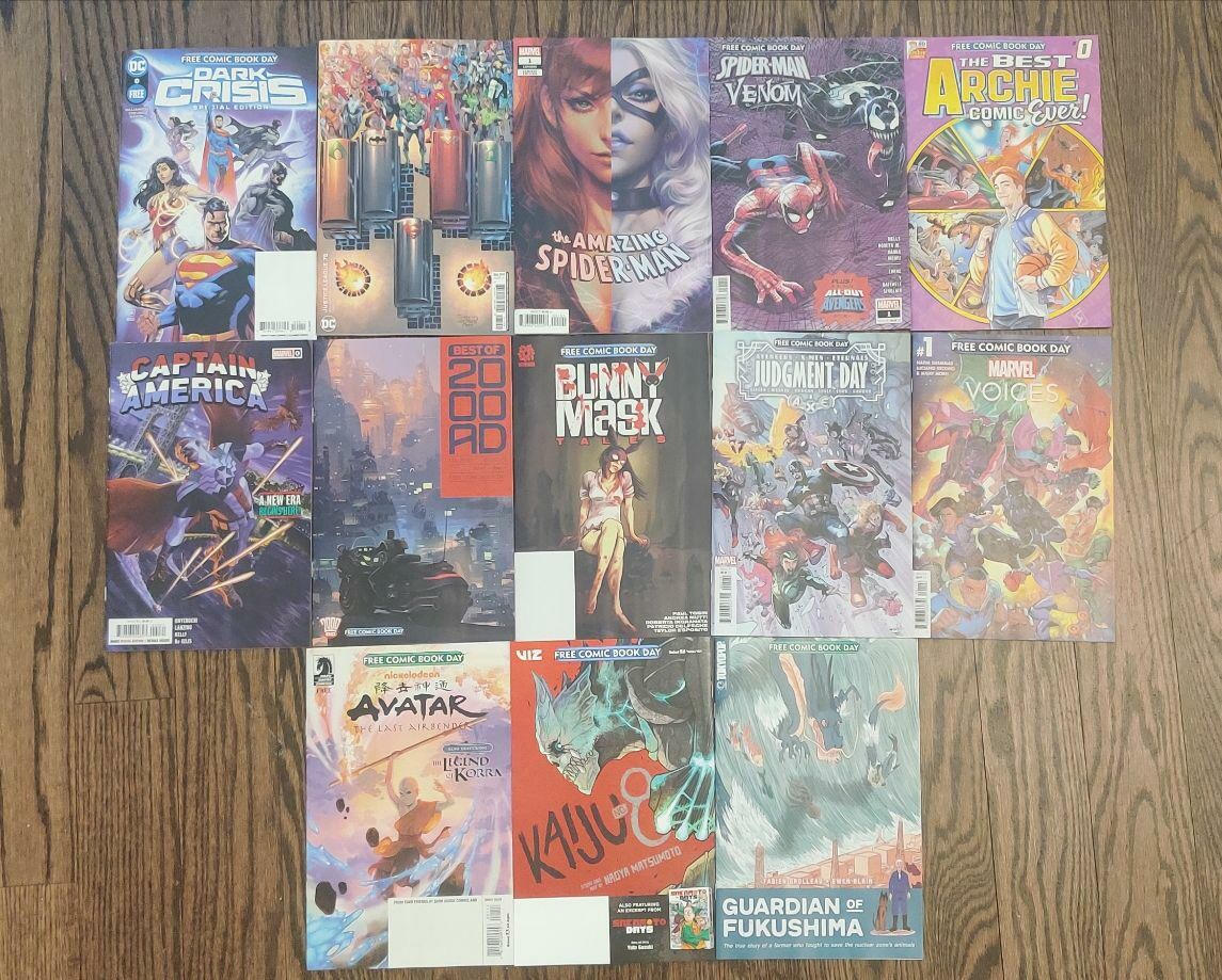 A picture of 13 comic books laid out on the floor