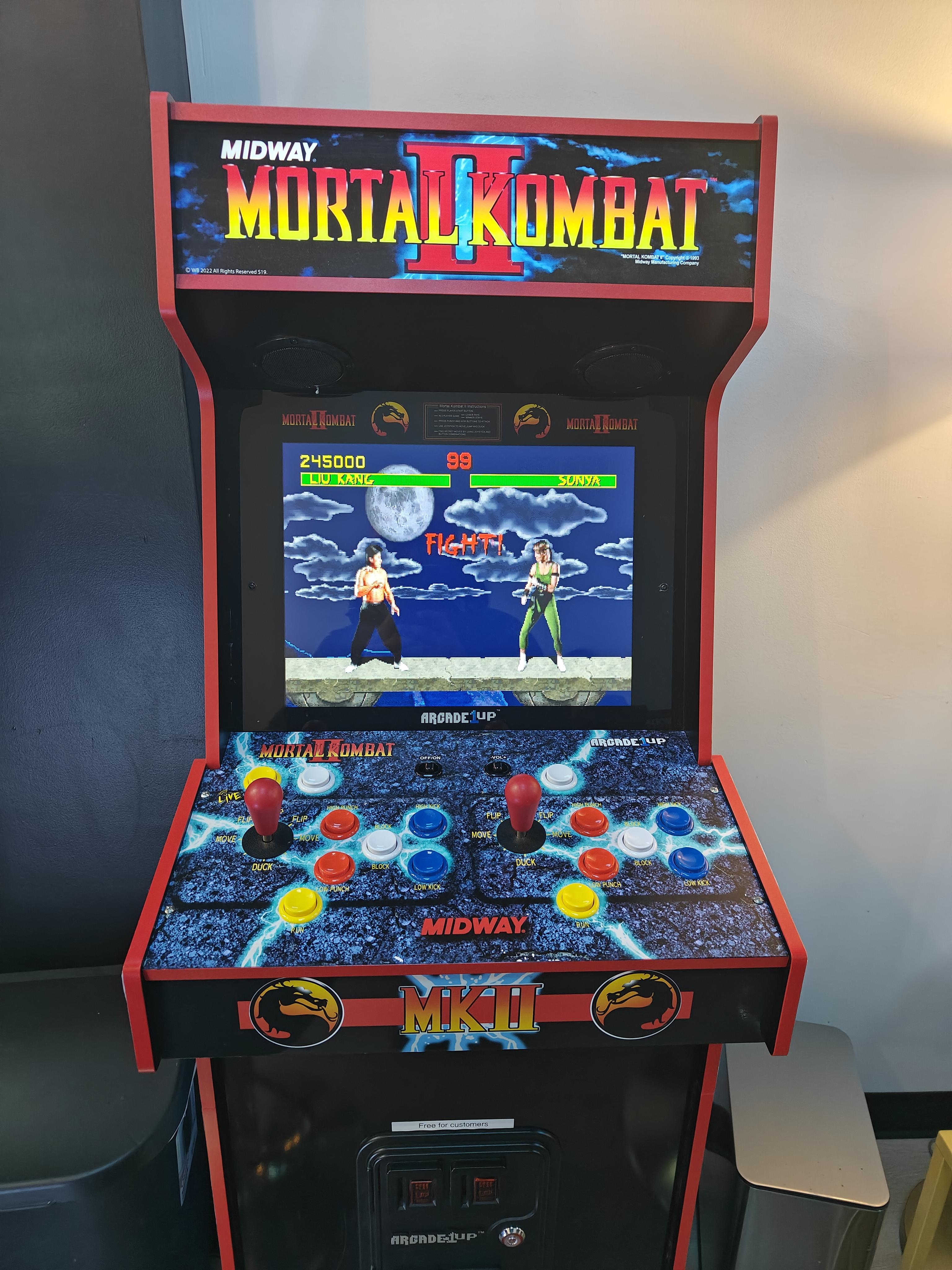 A classic video game arcade machine with Mortal Kombat II.