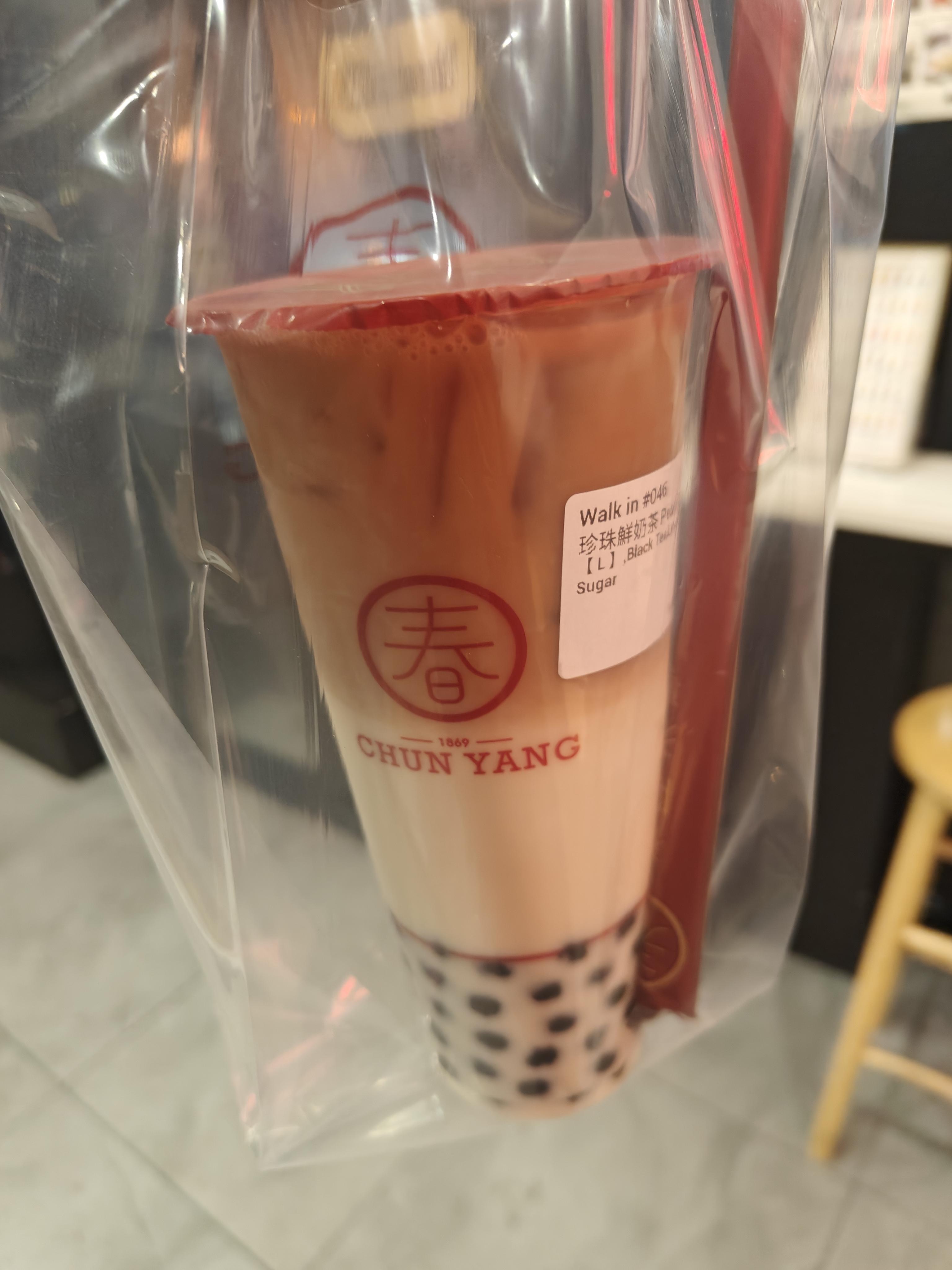 My black tea latte with boba, in a plastic bag